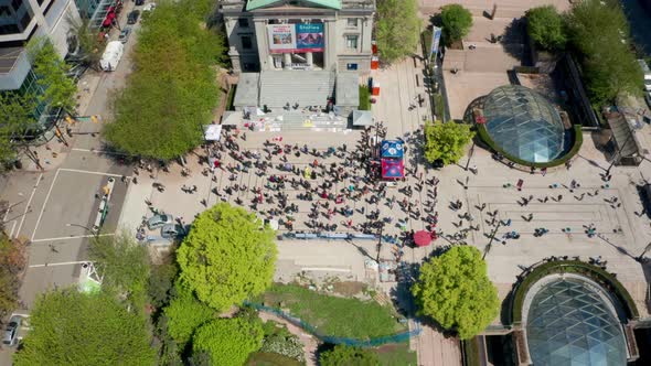 People gather to demonstrate in a public square, aerial drone view. Anti-vax anti-mask conservatives alt