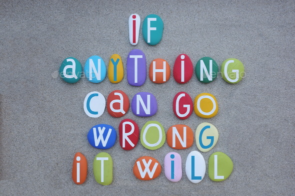 If anything can go wrong, it will, creative quote composed with multi colored stone letters over gre