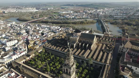 Mosque or Cathedral of Our Lady of Assumption and cityscape, Cordoba in Spain. Aerial tilt up