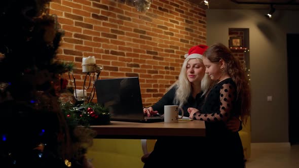 Females spending time together on christmas at living room indoors. Child and adult woman