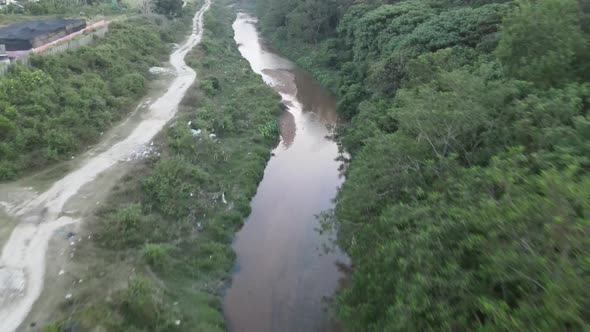 Drone flying towards small river in Perdana College Heights