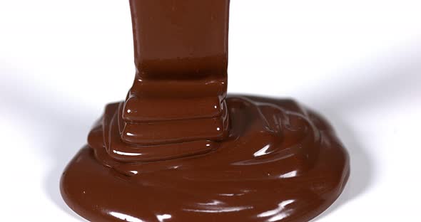 Chocolate Flowing on White Background, Slow Motion 4K alt
