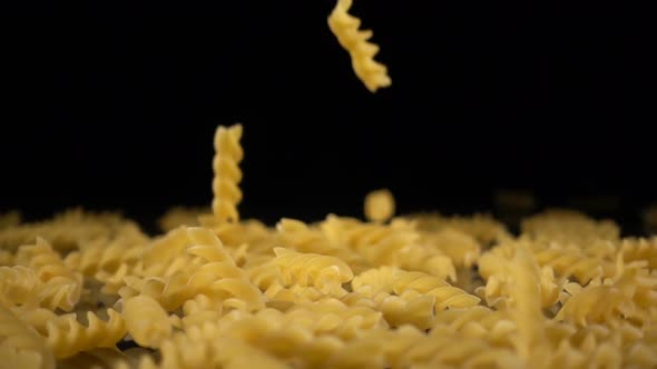 Pasta Falls Onto a Hard Black Surface alt