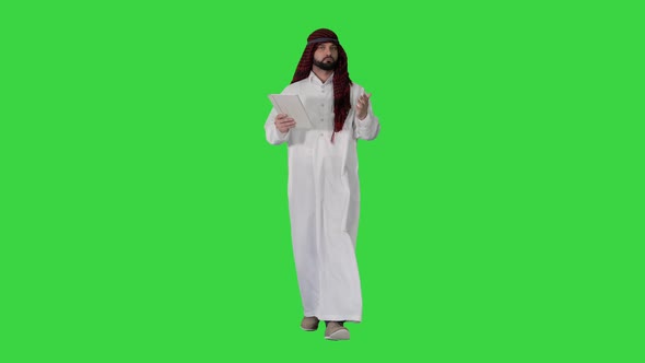 Sheikh Presenting Information or Product Using Digital Tablet on a Green Screen, Chroma Key. alt