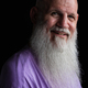 Portrait of happy man with long gray beard wearing purple t-shirt close-up shot - PhotoDune Item for Sale