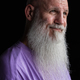 Portrait of man with long gray beard wearing purple t-shirt close-up shot - PhotoDune Item for Sale