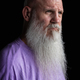 Portrait of man with long gray beard wearing purple t-shirt close-up shot - PhotoDune Item for Sale