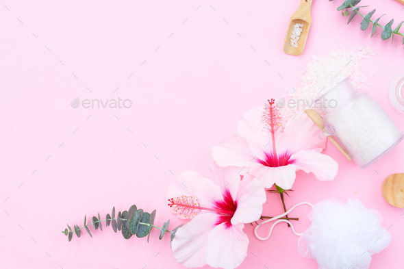 Beauty background with a natural soap, cream, towels and hibiscus flowers