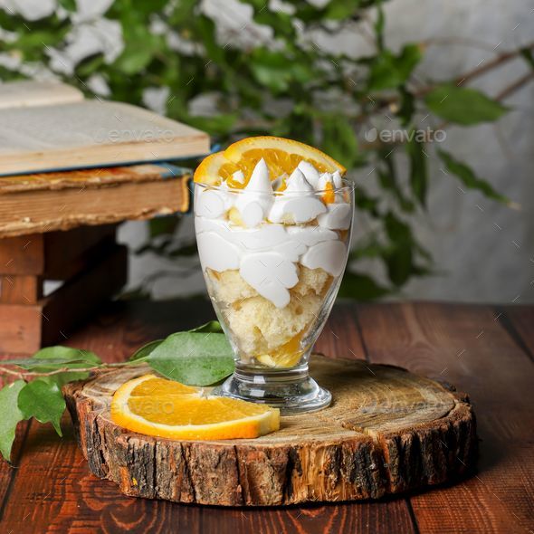 Delicious orange trifle served in a glass dish, with orange slices and whipped cream