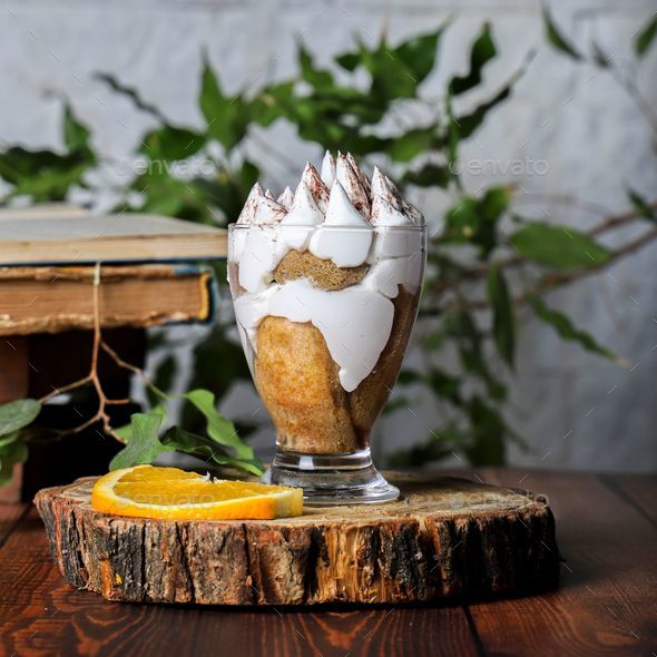 Delicious orange trifle served in a glass dish, with orange slices and whipped cream