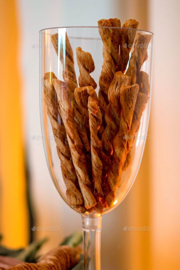 Up shot of a clear glass filled with fresh dried bread sticks