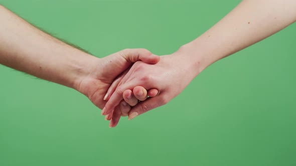 Two people holding hands alt