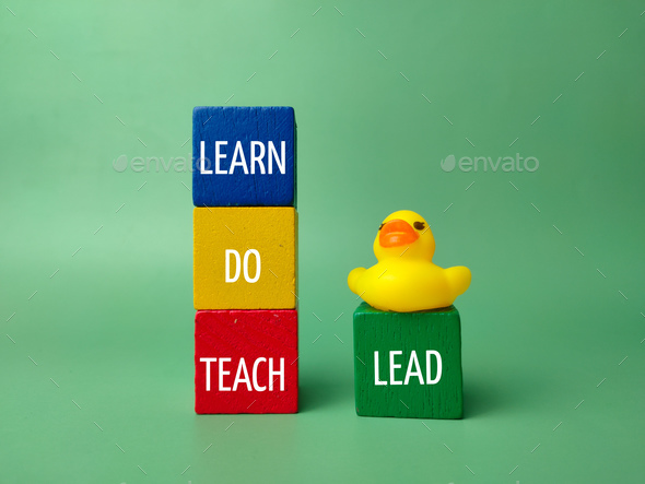 Yellow duck and colored cube with the word LEARN DO TEACH LEAD