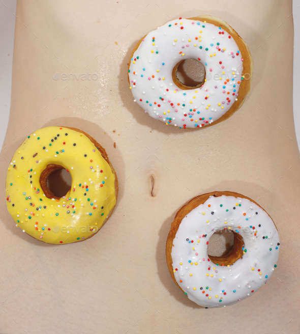 delicious donuts with sugar glaze on naked woman body Stock Photo by schum45