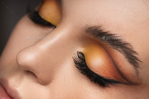 Female eyes with a colorful eyeshadow and eyebrow lamination