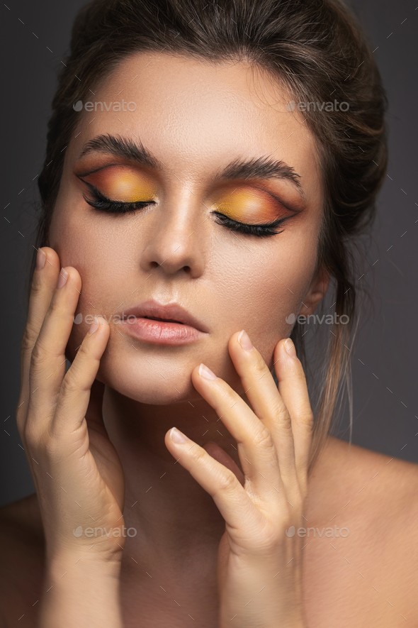 Sensual woman with a colorful eyeshadow and eyebrow lamination