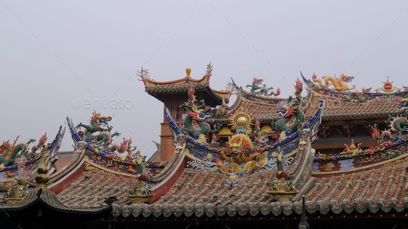 Ancient building with traditional Asian architecture on the roof of it - Stock Photo - Images