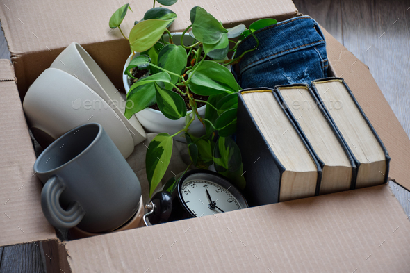 Cardboard box packed with personal belongings for moving