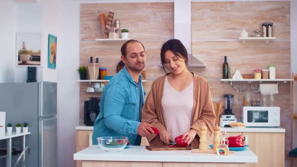 Cheerful Man in Kitchen with Wife alt