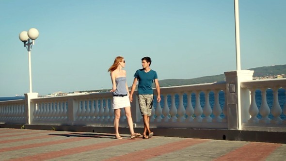 Couple Walking On the Embankment