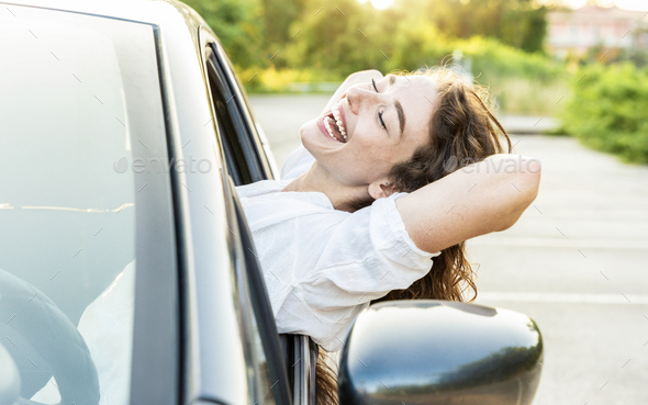 Photo of positive delightful woman driver enjoying car ride
