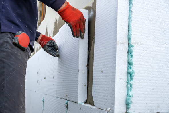 Insulation of facade wall with styrofoam sheets. Polystyrene insulation  boards with glue adhesive Stock Photo by bilanol