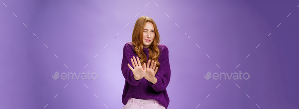 Gross take it away. Portrait of disgusted redhead woman step back and waving palms over body in