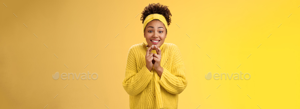 Thrilled cute charming african-american smiling girl cross fingers good luck press hands together