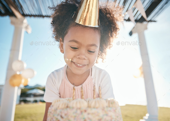 Girl, smile and happy birthday with cake in garden for special event with  hat or balloons. Party, d Stock Photo by YuriArcursPeopleimages