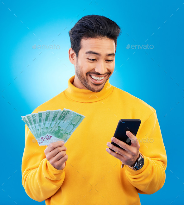 Man, phone and money in studio with prize, esports gambling or happy for success by blue background