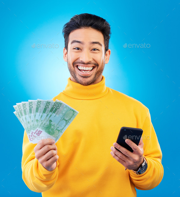 Man, phone and money fan in studio with prize, esports gambling or happy in portrait by blue backgr