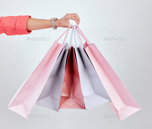 Fashion, studio or hand of woman with shopping bags for retail sale, product offer or discount deal