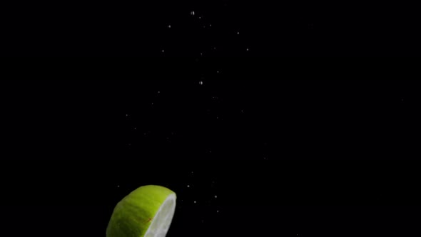 Lime Falling into Water Super Slowmotion, Black Background, lots of Air Bubbles, 4k240fps alt