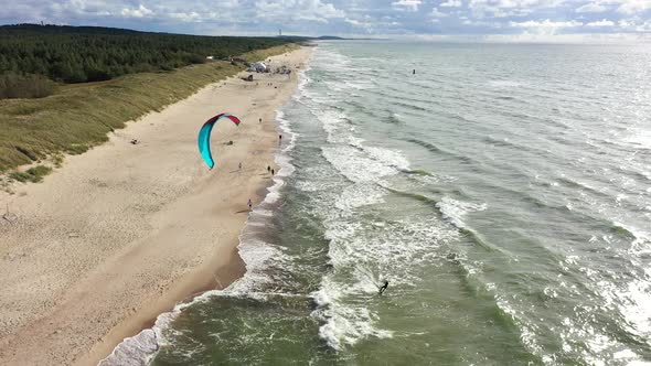 AERIAL: Surfer Riding Waves Very Close to Baltic Sea Shore alt