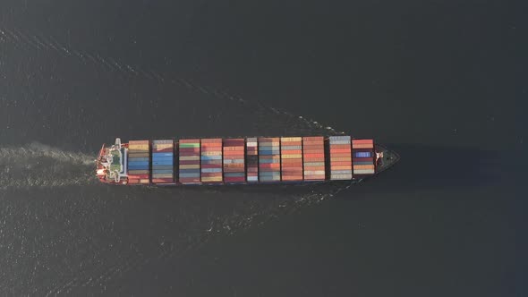Drone View Vertically Downward on the Movement of the Container Ship at Sea alt