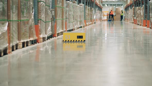 Storage Robot is Riding Along the Corridor Floor alt