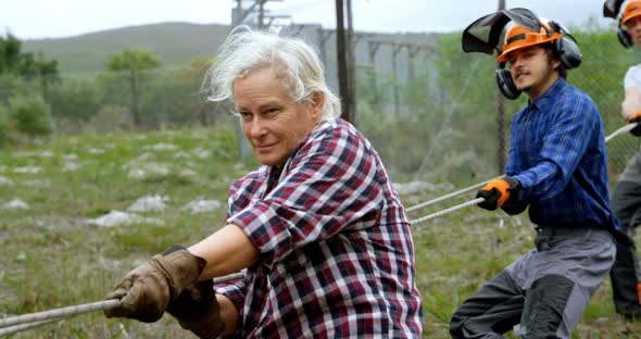 Lumberjacks pulling rope in the forest 4k alt