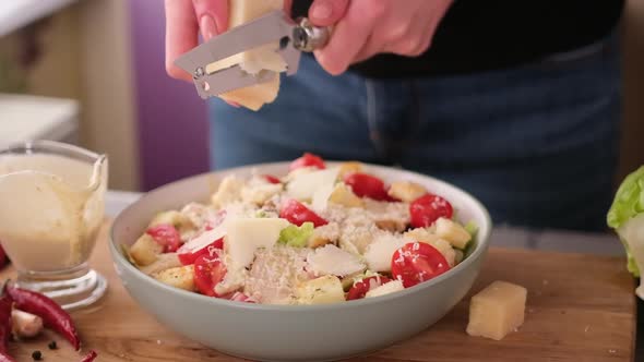 Cooking Caesar Salad Inside Deep Cooking Bowl  Slicing Parmesan Cheese alt