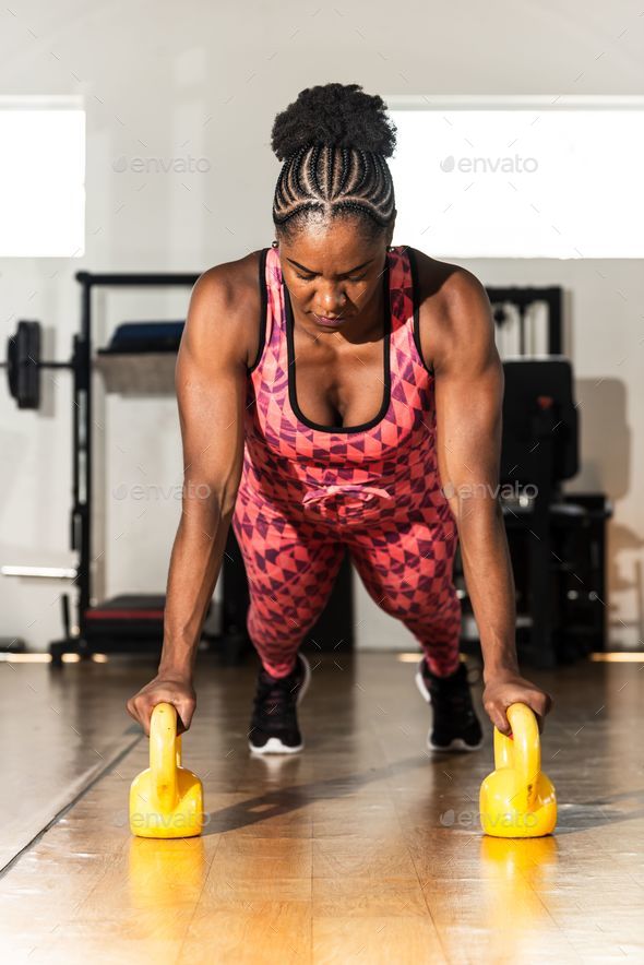 Strong Athletic Woman Bodybuilder With Dumbbells On Dark