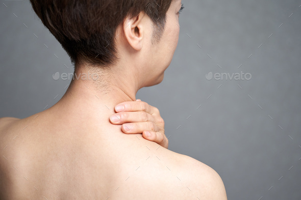 Middle-aged Japanese woman suffering from stiff shoulders