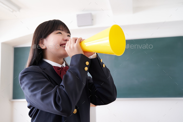 A Japanese junior high school girl cheering in her classroom