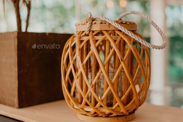 Decorative braided wicker basket with a rope handle, interior design ideas  Stock Photo by wirestock