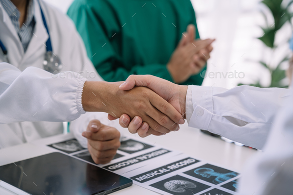 Doctor and Nursing assistant patient meeting at the hospital and shaking hands