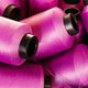 High-angle vertical shot of an organized display of colorful pink thread  spools Stock Photo by wirestock