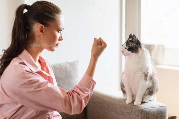 Woman Having Problem With Cat Discipline Showing Fist Indoor
