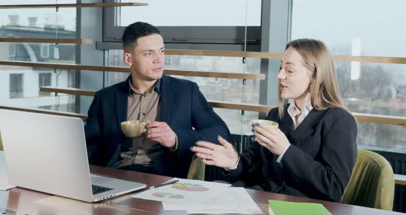 Man and a Woman Discussing Work in the Brightly Lit Modern Office. Male and Female Working with alt