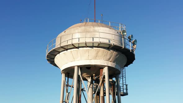 Water tower - elevated liquid storage tank. Metal reservoir for compressed gases hazardous chemicals alt