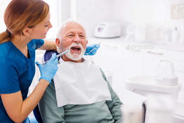 Dental care specialist applying local anesthetic to patient
