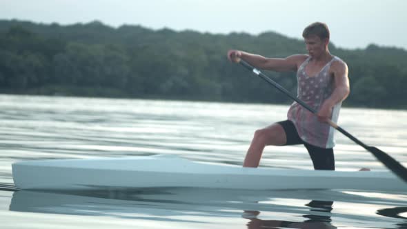 Young Man Paddling a Canoe