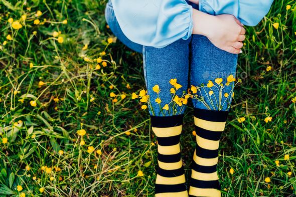 Close up young female wearing jeans and striped black and yellow